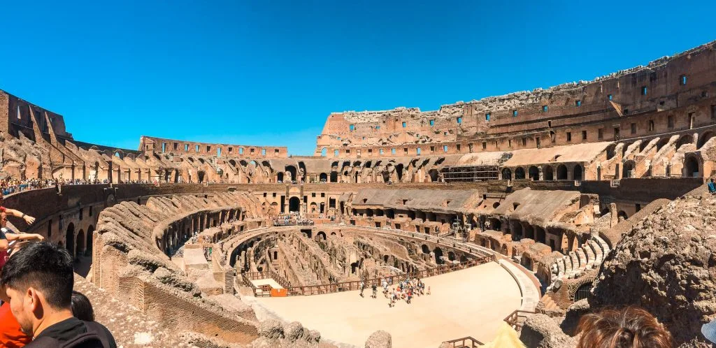 A spectacular panorama photo inside the Colosseum showing the amazing architecture of the amphitheater. A MUST