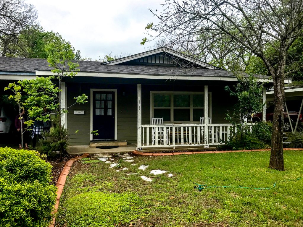 A dark green rental house with a futon yard for a weekend in Fredericksburg, Texas.