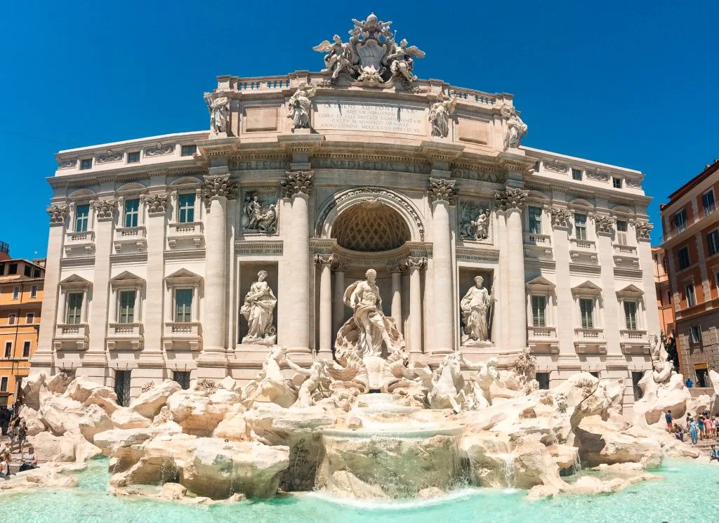 A bright panorama photo of the Trevi Fountain in Rome - a must see during your 2 days in Rome itinerary.