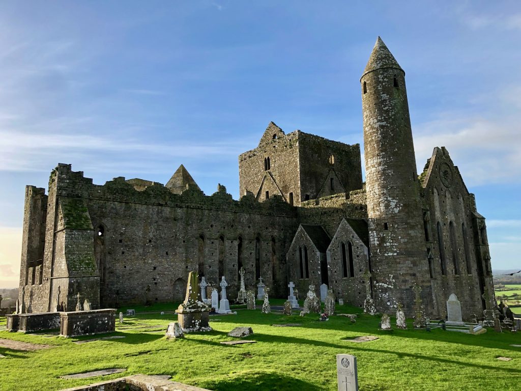 Rock of Cashel sits majestically above the city, Cashel, Ireland. It is a stunning fortress full of history dating back to the 12th century. Though it is still standing tall, the fortress is exactly what you would imagine when thinking of a medieval fortress in ruins.