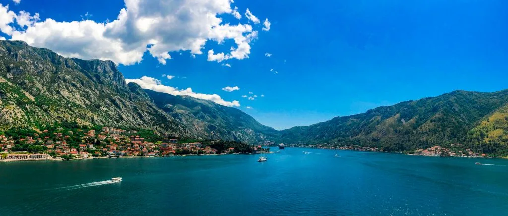 Landscape photo looking out into Bay of Kotor with green mountains surrounding the water.