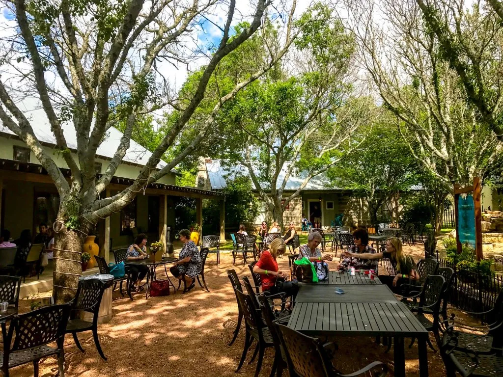 A beautiful outdoor seating area with trees providing shade at Fiesta Winery.