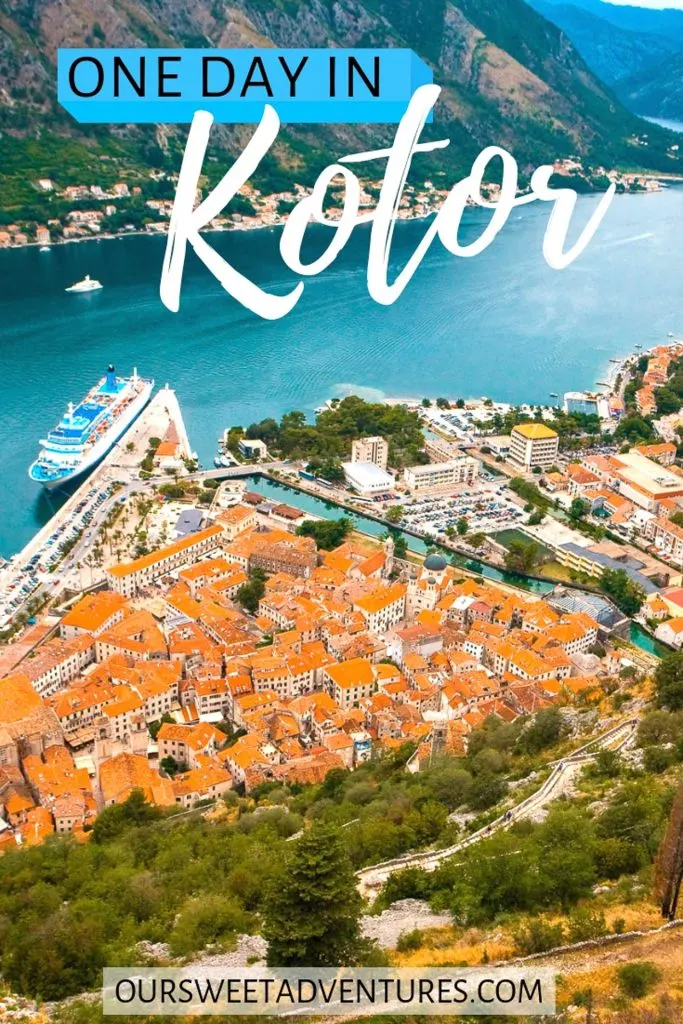 Red roof top houses sitting close together making the shape of a triangle on the Bay of Kotor with a cruise ship docked at the port and a text overlay "One Day in Kotor".