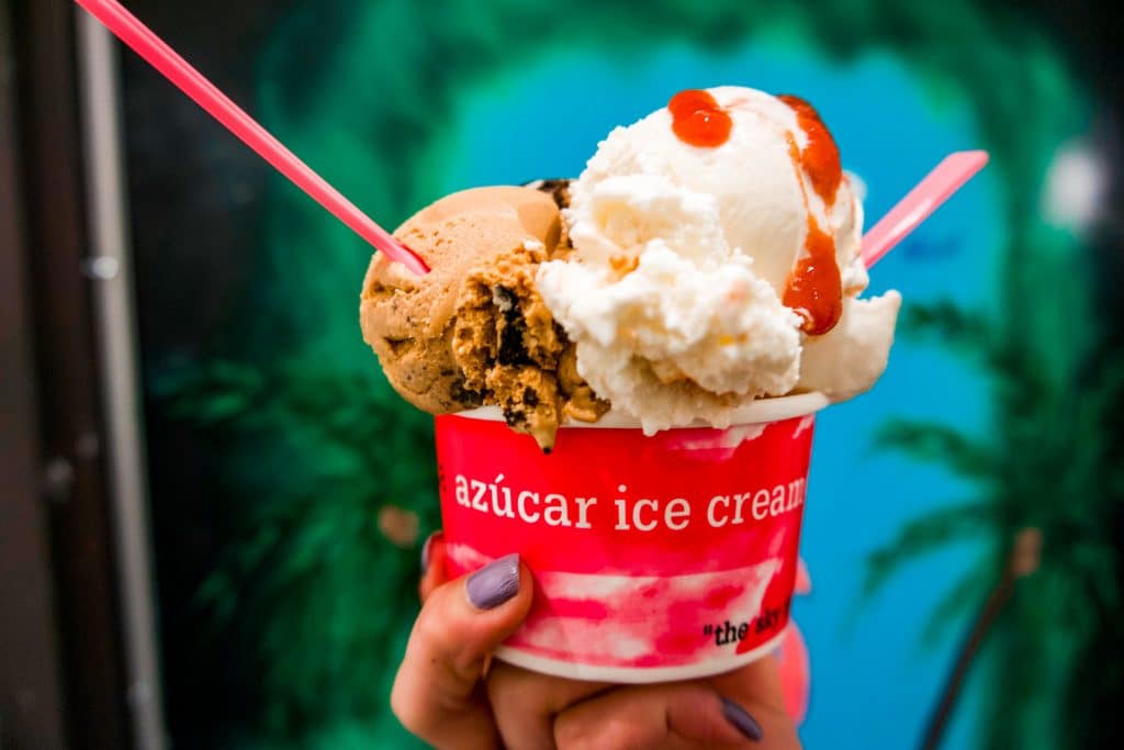 Two scoops of Cuban ice cream inside a bright pink cup from Azucar Ice Cream. 