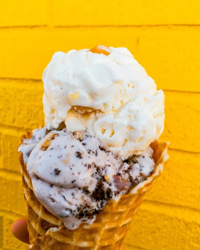 Two giant scoops of ice cream with a bright yellow background from MELT in Ft. Worth. 