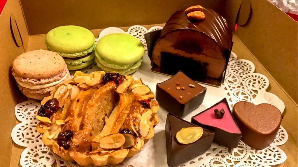 A variety of European and American desserts (macarons, apple pie, chocolate cake, and truffles) from Sucrose bakery in St. Charles, MO.