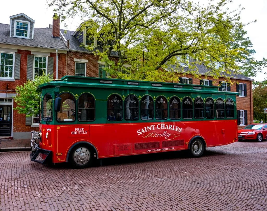 A red and green trolley in St. Charles on Main Street.