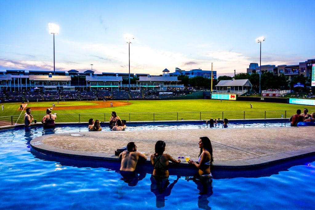 A bunch of people hanging out in the Choctaw Lazy River at the RoughRiders baseball game which is one of the best things to do in Frisco.