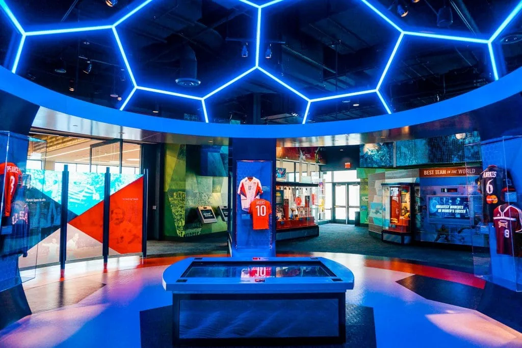 A pano of the Soccer Hall of Fame gallery with a neon blue soccer ball on the ceiling.