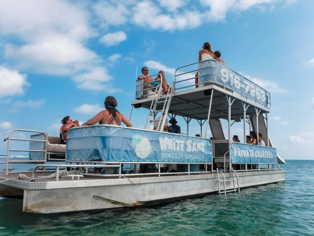 A double-decker pontoon boat with a lot of people onboard - definitely one of the best things to do in the Grand Cayman. 