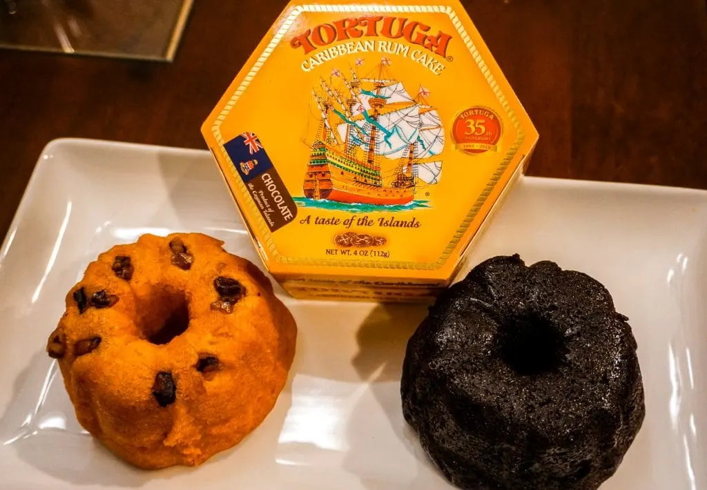 Two Tortuga Rum Cakes - left is original and the right is chocolate. In the top middle is a yellow box that says Tortuga Rum Cake.