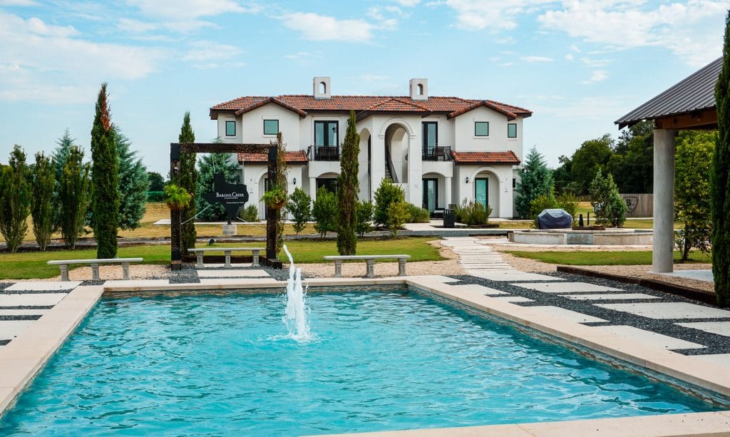 Gorgeous view of a fountain with a European villa in the backyard from Barons Creek Vineyard in Fredericksburg, Texas.