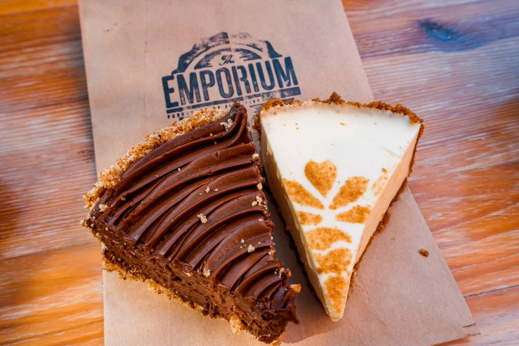 Two beautiful slices of pie from Emporium Pies. Pictured on the left is a chocolate pie and on the right is a lemon chiffon pie. 