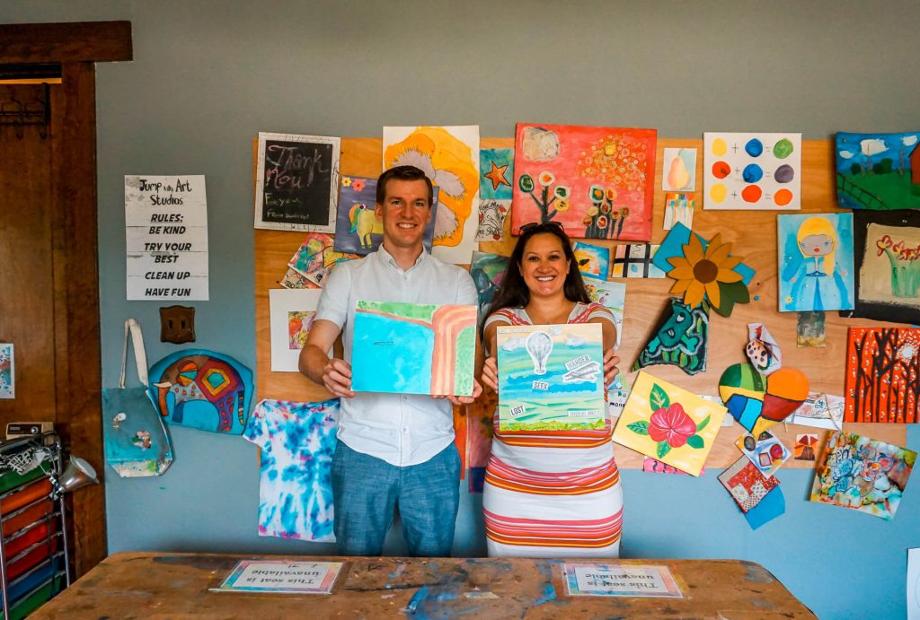 A couple showing their art canvas from Jump Into Art Studios during a romantic weekend getaway in McKinney, Texas.