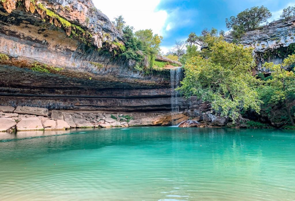 A box canyon with a towering waterfall cascading into a pool. No Texas Hill Country road trip is complete with a trip to Hamilton Pool Preserve.