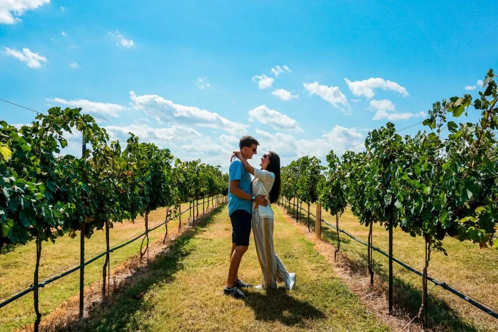 A couple in a wine vineyard in Fredericksburg, Texas - one of the best destinations on a Texas Hill Country road trip.