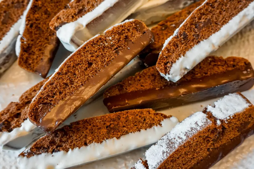 Triple Chocolate Biscotti dipped in dark and white chocolate laying sideways. 