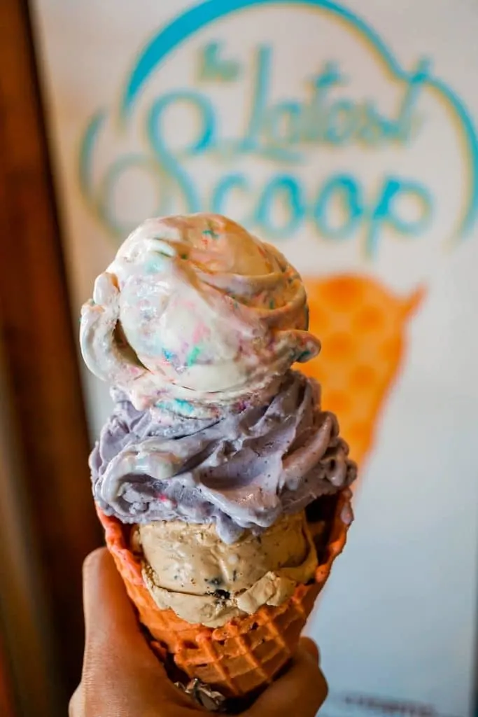 A triple scoop of ice cream at The Latest Scoop. Espresso bean at the bottom, blueberry lavender in the middle, and birthday cake with sprinkles on top.