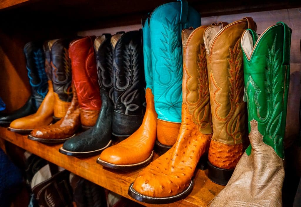 A row of vibrant colorful M.L. Leddy boots.