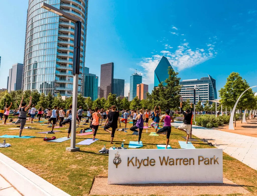 People doing yoga ar Klyde Warren Park in Dallas.