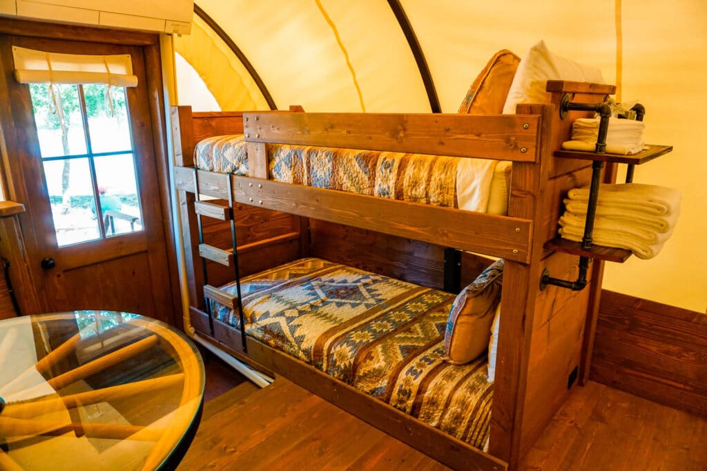 A bunked bed set inside a Conestoga Covered Wagon.