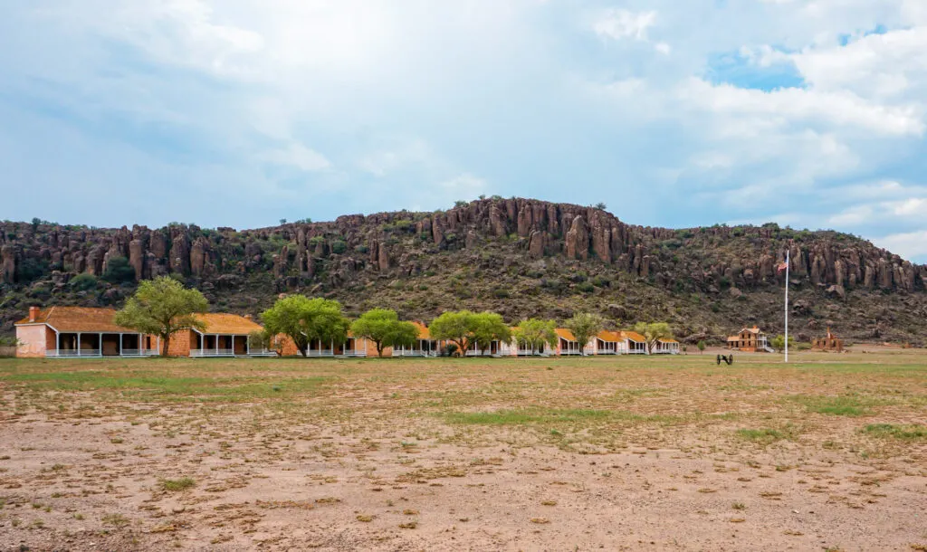 Fort Davis National Historic Site - a must visit for history buffs and one of the best things to do in Fort Davis. Davis Mountains are set behind a row of restored fort buildings.