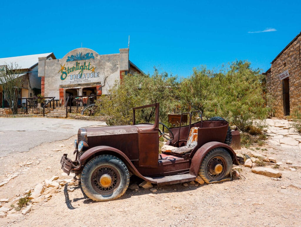A rusty old car in front of the famous Starlight Theatre in Terlingua, Texas - one of the best restaurants in West Texas.