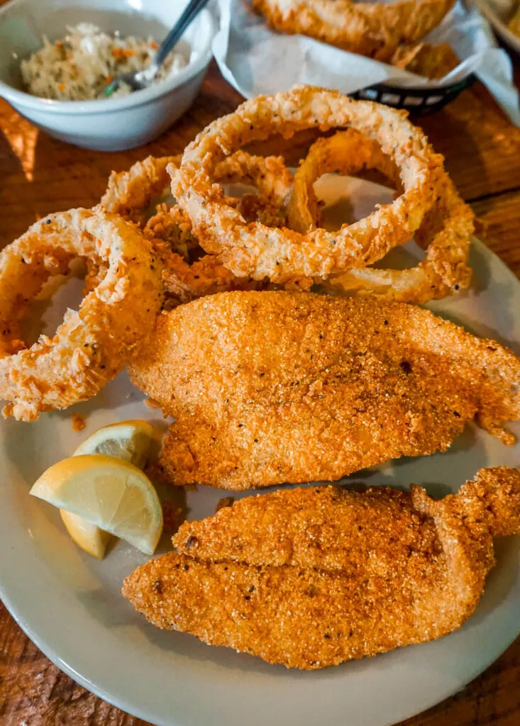 A plate of fried catfish and fried onion rings from Big Pines Lodge Restaurant and Watering Hole.