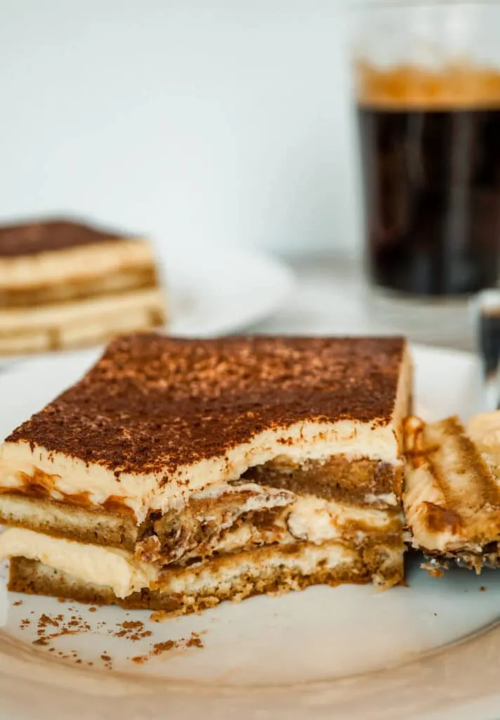 A slice of Tiramisu with a bite taken out of it.