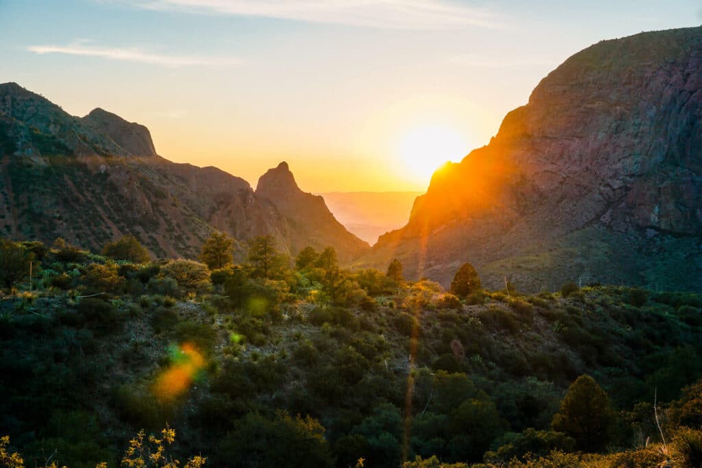 The sun setting behind mountains within the "window view" at Big Bend National Park. You cannot miss this view during your 3 days in Big Bend National Park.