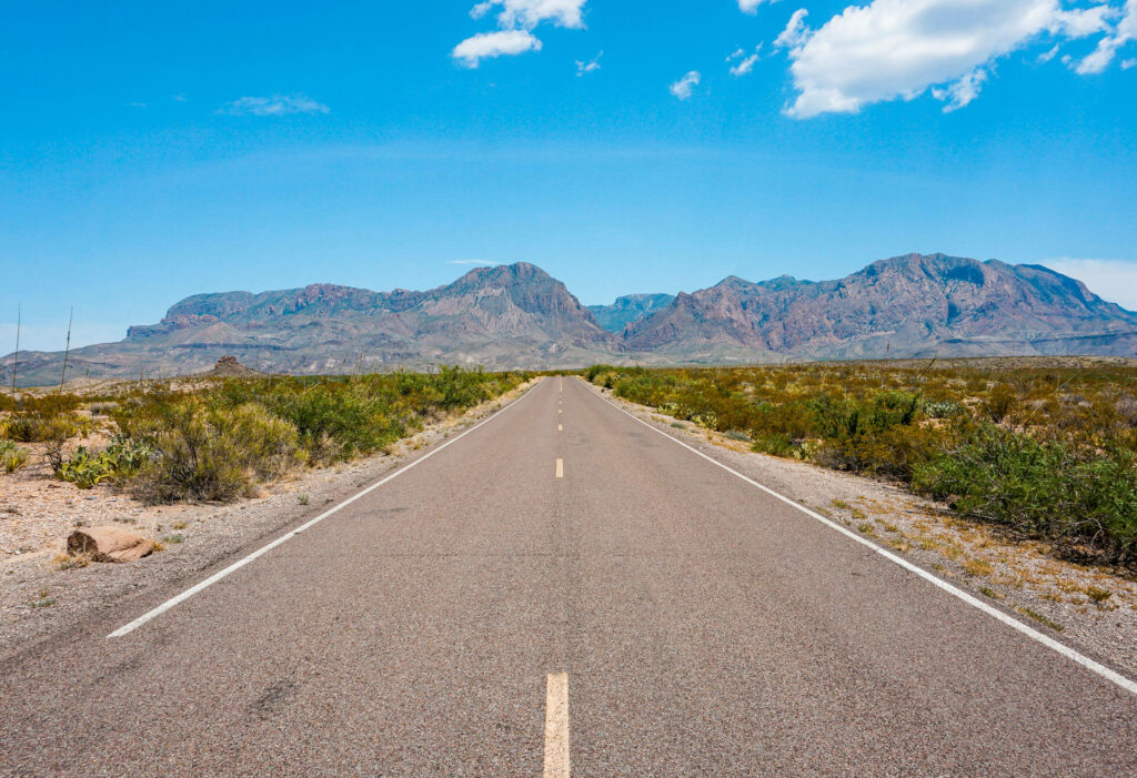 The Ross Maxwell Scenic Drive road leading towards the mountains at Big Bend National Park.