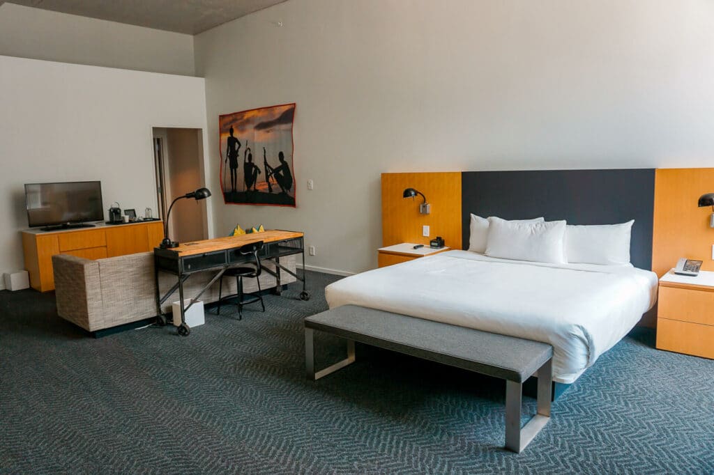 A King sized bed and open concept living area in a spacious hotel room at 21c Museum Hotel in Oklahoma City.