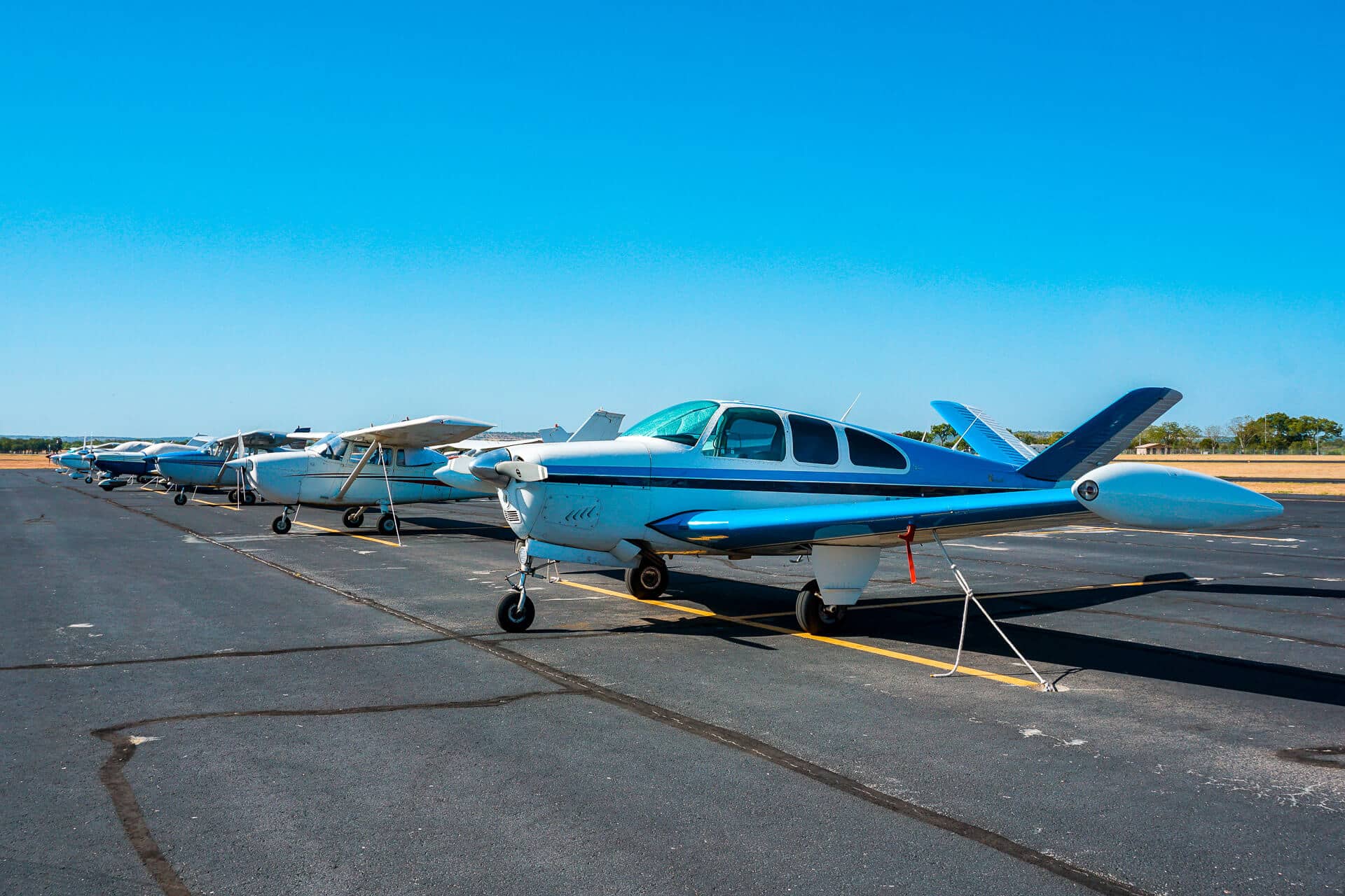 a line of personal aircrafts at the Fredericksburg runway