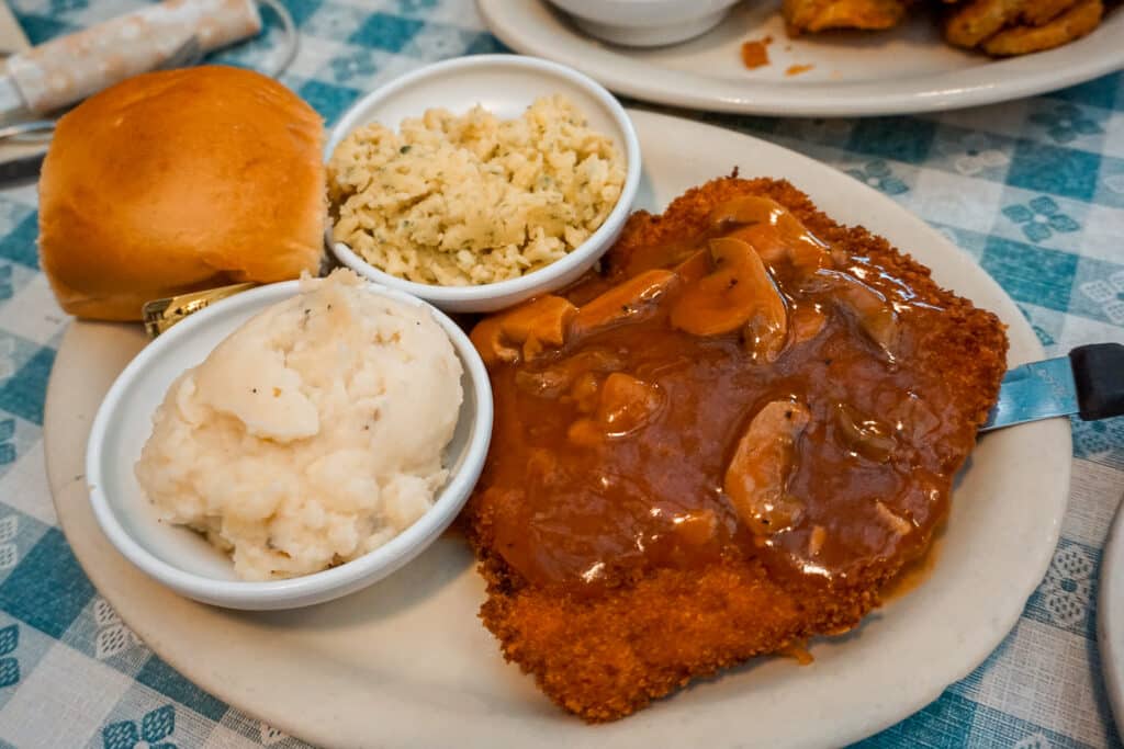 A plate of German cuisine (mashed potatoes, spaetzle, and schnitzel) from the Auslander in Fredericksburg, Texas.