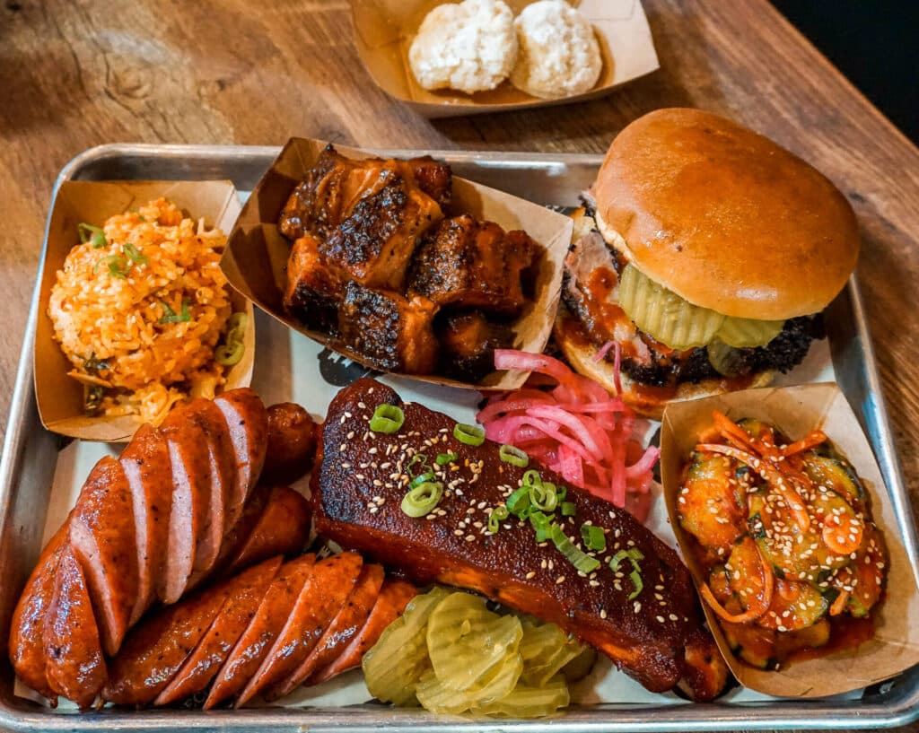A plate full of South Texas-style BBQ with Korean side dishes from Eaker BBQ.