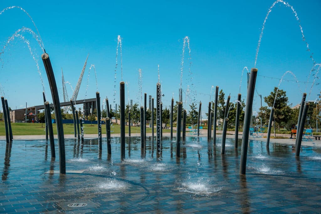 A splash area with tall water jets spraying water. This is located at Scissortail Park and one of the best things to do in Oklahoma City with toddlers. 