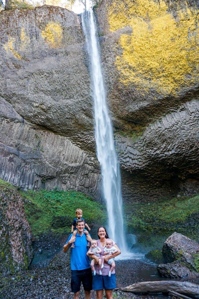 A family standing in front of the plunging Latourell Falls in Columbia River Gorge
