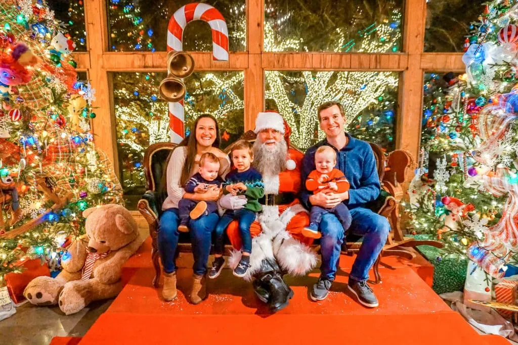 A family of five taking a photo with Santa at Miracle on 134th Street in Celina, Texas.