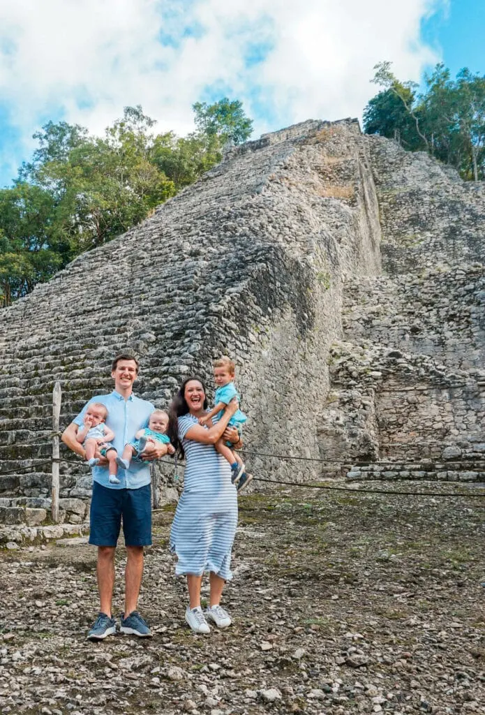 A family in Tulum with kids in front of Coba ruins.