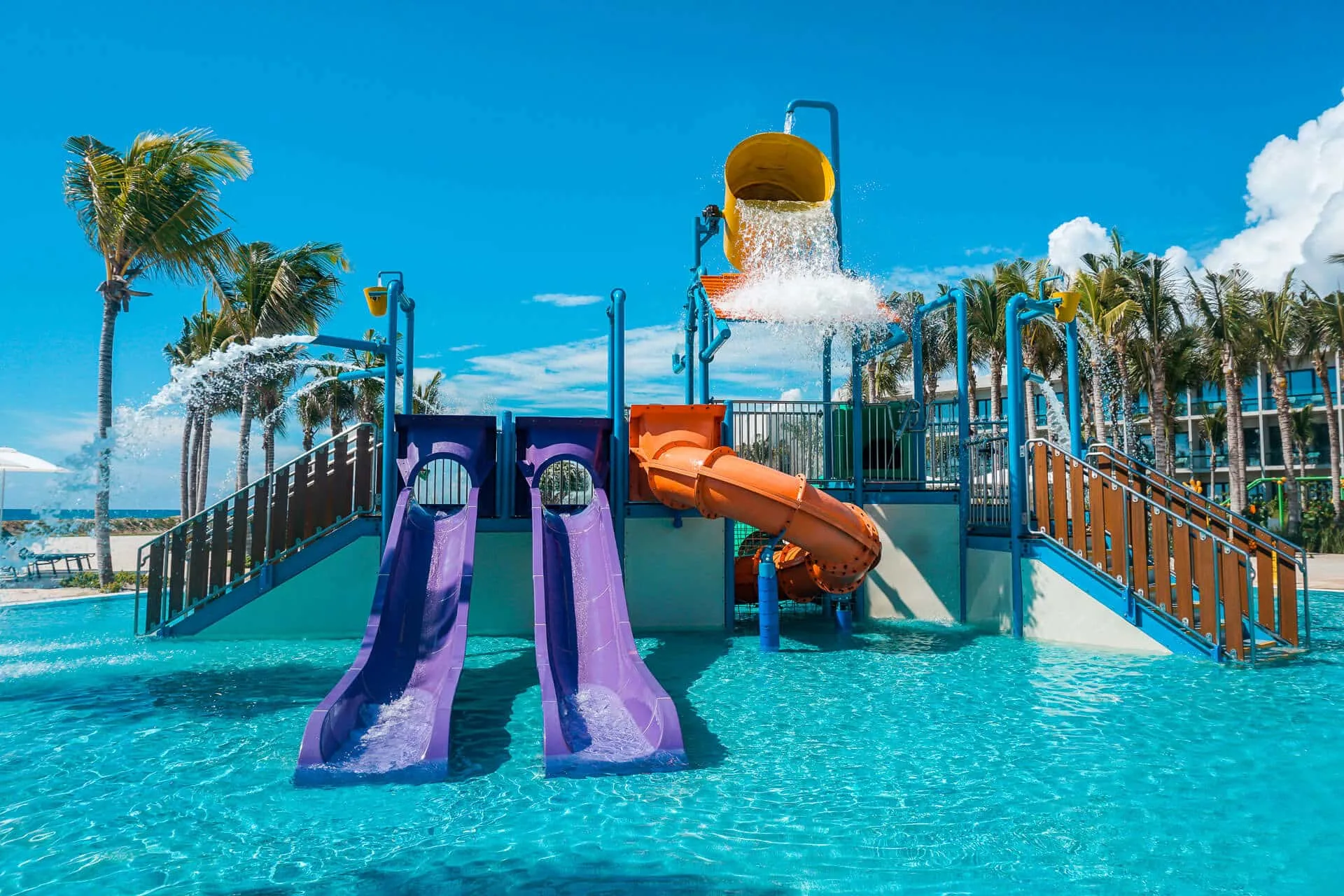 An epic waterpark with four water slides and a water bucket at Hilton Tulum Riviera Maya Resort.