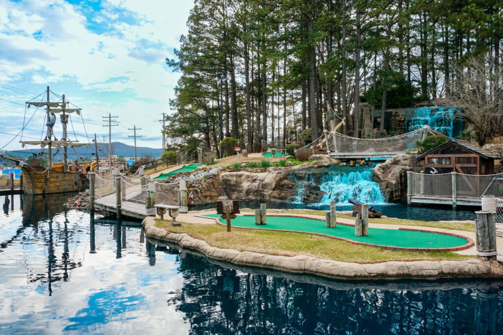 A pirates ship and cascading waterfall with green putt putt courses at Pirate's Cove in Hot Springs, Arkansas. 
