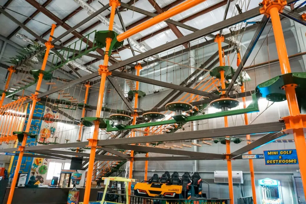 An orange and green, ceiling-high multi-layer rope course at T-Rex Fun Spot in Hot Springs, Arkansas.