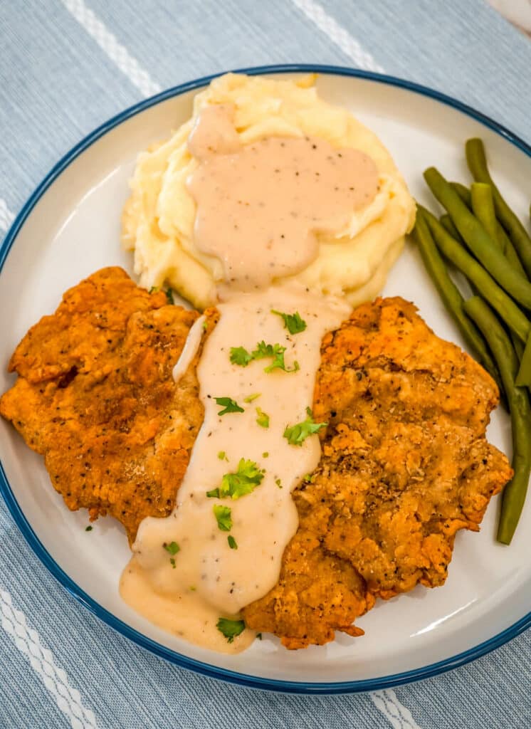 Texas Chicken Fried Steak and mashed potatoes with Beer Gravy and a side of green beans. 