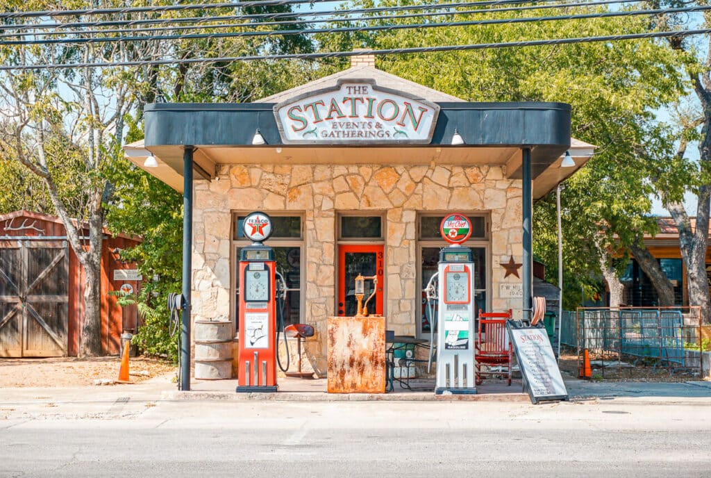 A charming gas station with old gas pumps located on Mercer Street in Dripping Springs.