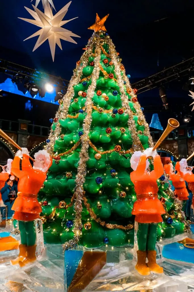 An ICE! display of a highly decorative, larger-than-life Christmas tree carved from ice with trumpet players. One of the best Christmas things to do in Dallas!