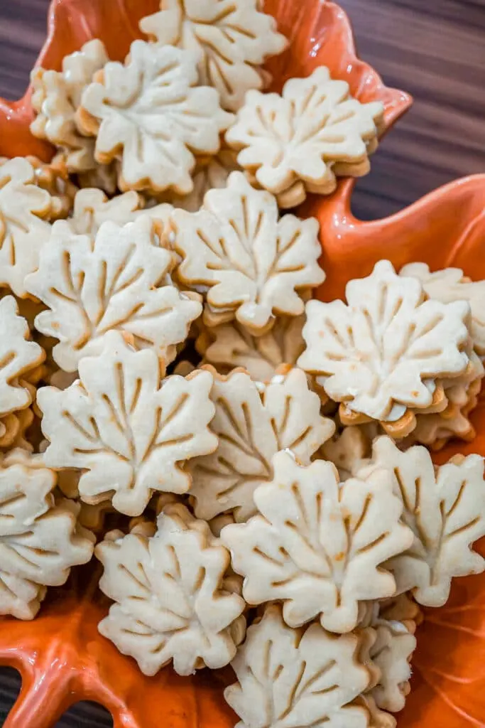 A bowl full of Maple Leaf Cream Cookies.