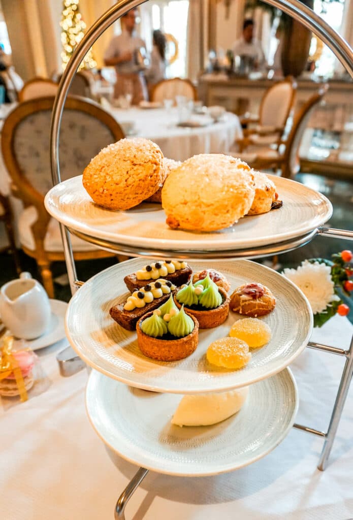 A three tier plate of pastries from the Adolphus Hotel's iconic holiday tea service - one of the best Christmas things to do in Dallas.