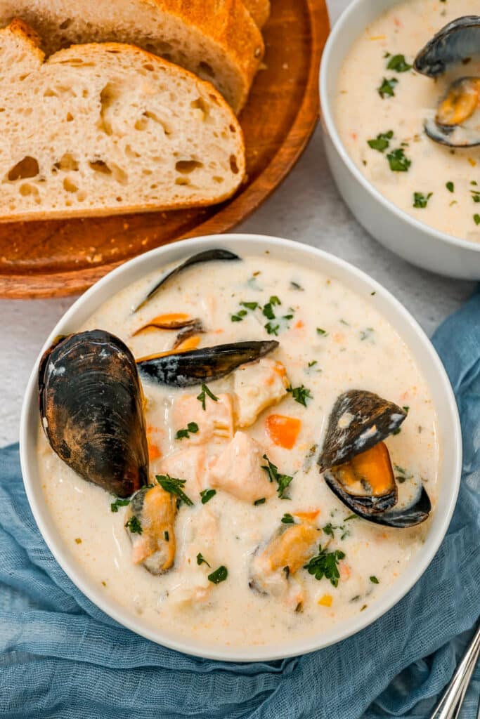 A bowl of Irish Seafood Chowder with open mussels, chunks of cod, and salmon. 