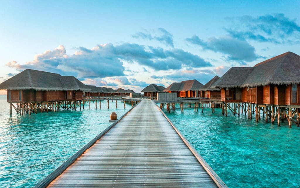 A boardwalk leading to several overwater villas at the Conrad Maldives Rangali Island. 