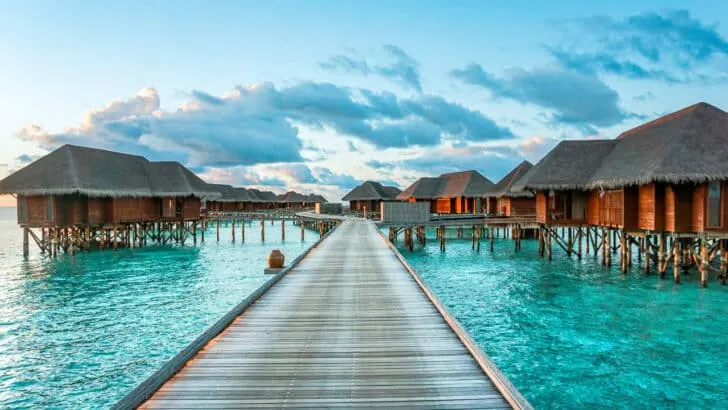 A boardwalk leading to several overwater villas at the Conrad Maldives Rangali Island.